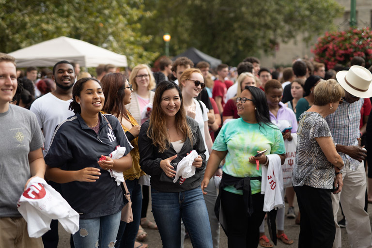 Students standing at an outdoor welcome event